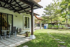 a house with a patio with a table in the yard at Double Storey Homestay at Cahaya SPK Shah Alam in Shah Alam