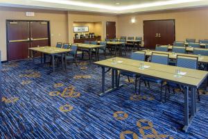 a conference room with tables and chairs on a blue carpet at Courtyard Boston-South Boston in Boston