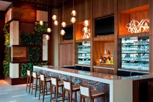 a bar in a restaurant with wooden walls and chairs at The Westin Birmingham in Birmingham