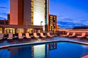 a hotel with a pool and chairs and a building at The Westin Birmingham in Birmingham