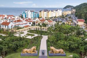 a resort with two statues of horses in front of a city at JW Marriott Phu Quoc Emerald Bay Resort & Spa in Phu Quoc