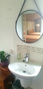 a bathroom with a white sink and a mirror at Southern Sky Glamping in Mount Tamborine