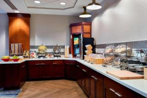 a large kitchen with wooden cabinets and a counter at Fairfield Inn Suites Indianapolis Downtown in Indianapolis