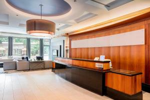 an office lobby with a desk and a reception counter at Courtyard by Marriott Boston Brookline in Brookline