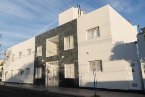 een wit gebouw aan de kant van een straat bij Apartamento Tomás Jofré in San Luis