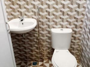 a bathroom with a toilet and a sink at RedDoorz Syariah At Harley Hotel Sabang in Sabong