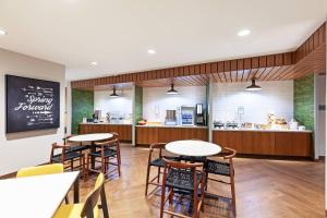 a restaurant with tables and chairs and a counter at Fairfield Inn & Suites by Marriott Liberal in Liberal