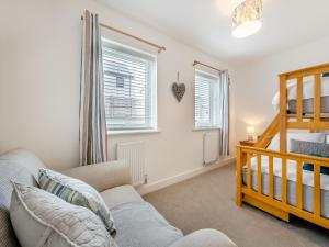 a living room with a couch and a bunk bed at Phoenix House in Kingsbridge