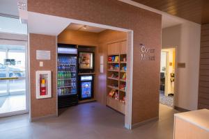 a store entrance with a coffee market sign and a refrigerator at Fairfield Inn & Suites By Marriott Alexandria in Alexandria