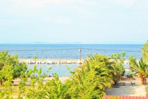 a view of the beach and the ocean from a resort at Melina Apartment in Loutrópolis Thermís