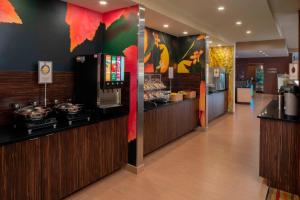 a restaurant lobby with a counter and a bar at Fairfield Inn & Suites by Marriott Batesville in Batesville