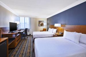 a hotel room with two beds and a desk and a computer at Fairfield by Marriott Inn & Suites Herndon Reston in Herndon