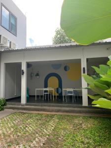 a house with a patio with tables and chairs at PassGo Thamrin in Jakarta