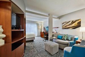 a hotel suite with a living room and a bedroom at Courtyard Philadelphia/Langhorne in Langhorne