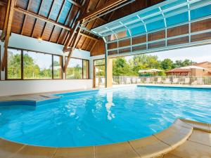 an indoor pool with blue water in a house at Beautiful apartment in a picturesque city in the Dordogne in Bergerac