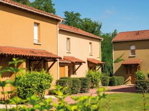 a row of houses with bushes and trees at Beautiful apartment in a picturesque city in the Dordogne in Bergerac