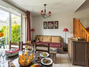 a living room with a table and a couch at Beautiful apartment in a picturesque city in the Dordogne in Bergerac