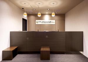 an office lobby with a reception desk and benches at Hotel Crown Hills Ueno Premier in Tokyo