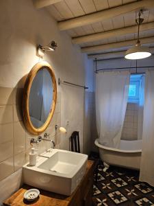 a bathroom with a tub and a sink and a mirror at THE OLIVE PRESS - Alentejo in Castelo de Vide