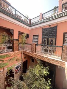 an apartment building with balconies and trees at Riad Musa in Marrakesh