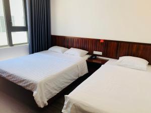 Postel nebo postele na pokoji v ubytování Luu Gia Hotel