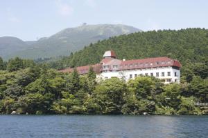 a large building on the shore of a lake at Odakyu Hotel de Yama in Hakone
