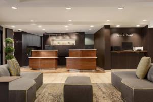 a lobby with a check in counter and a waiting room at Courtyard Greenville in Greenville