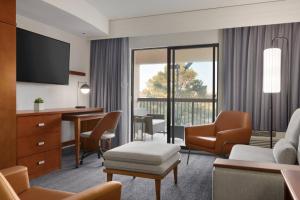 a hotel room with a desk and a chair at Courtyard Greenville in Greenville