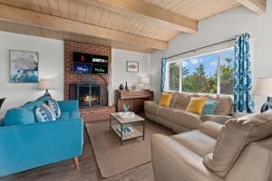 a living room with a couch and a fireplace at LOVELY Ocean View Beach House 3BR Sleeps 9 in San Diego