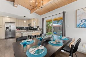 a dining room and kitchen with a table and chairs at LOVELY Ocean View Beach House 3BR Sleeps 9 in San Diego