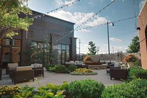 a patio with chairs and tables and a building at Courtyard by Marriott Columbus OSU in Columbus
