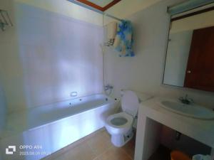 a bathroom with a toilet and a sink and a tub at SM. Beach Side Place in Hua Hin