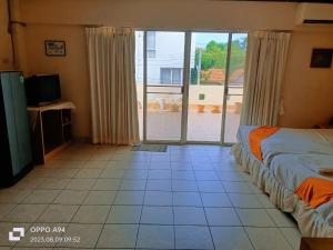 a bedroom with two beds and a sliding glass door at SM. Beach Side Place in Hua Hin