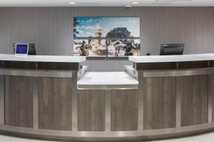 a lobby with a reception desk with a large painting on the wall at Residence Inn Kansas City Country Club Plaza in Kansas City