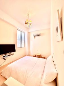 a bedroom with a bed and a flat screen tv at Love Green in Green Island