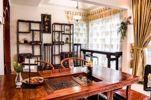 a dining room with a wooden table and chairs and a window at Wangsa Maju Luxury Villa with Private Pool-12pax in Kuala Lumpur