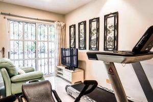 a living room with a treadmill and a television at Wangsa Maju Luxury Villa with Private Pool-12pax in Kuala Lumpur