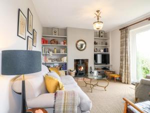 a living room with a couch and a table at Lucky Cottage in Foxt