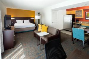 a hotel room with a bed and a living room at Residence Inn San Diego La Jolla in San Diego
