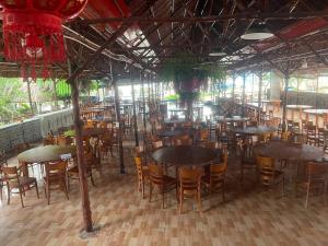 a group of tables and chairs in a restaurant at Tân Thành Resort in Ke Ga