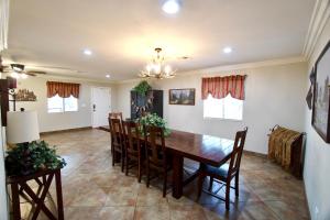 a dining room with a wooden table and chairs at Cabin for Big Families & Groups! in Pinetop-Lakeside