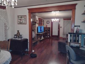 a living room with a couch and a table and a television at Quiet FULL-SIZE bed close to town 420 friendly in Trinidad