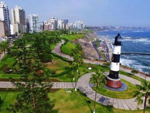 a lighthouse in a park next to the ocean at Miraflores habitación separada con privacidad dentro de departamento compartido in Lima