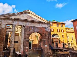 an old building with an arch in a city at Smart Lodging Prime in Rome