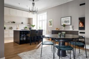 a kitchen and dining room with a table and chairs at Sophisticated apartment in Oslo in Oslo