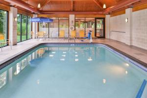 a swimming pool in a house with a child playing in it at Fairfield Inn Corning Riverside in Corning