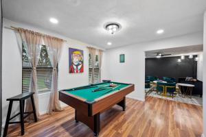 a living room with a pool table in it at Green Resort: 3bd/2.5 bath near AT&T Stadium in Arlington