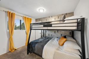 a bedroom with two bunk beds and a window at Green Resort: 3bd/2.5 bath near AT&T Stadium in Arlington