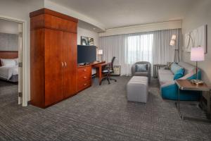 a hotel room with a couch and a desk at Courtyard Dunn Loring Fairfax in Merrifield