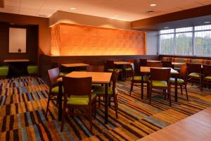 a restaurant with tables and chairs in a room at Fairfield Inn & Suites by Marriott Plymouth White Mountains in Plymouth